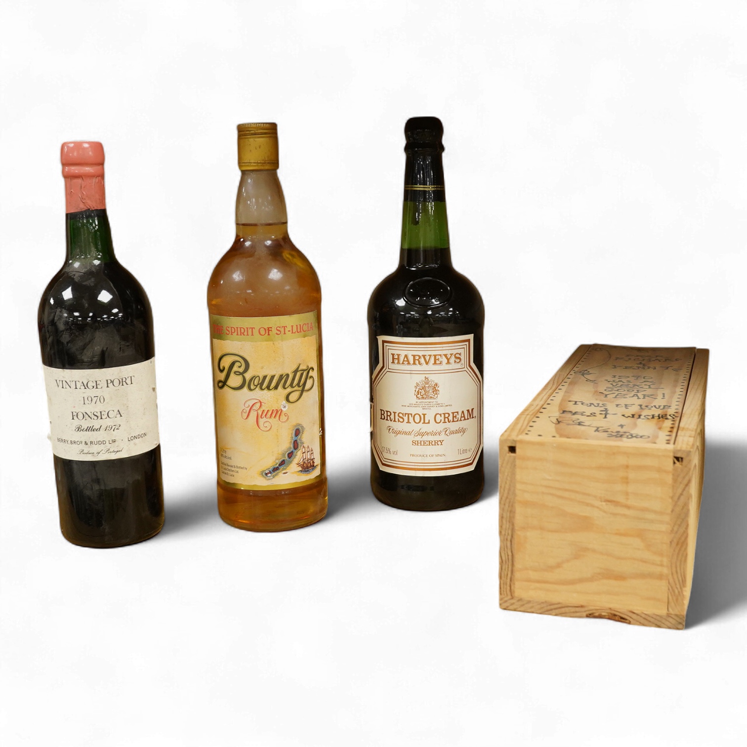 A bottle of Fonseca 1970 vintage port, a bottle of 1970 Chateau Grand-Puy-Lacoste, a litre bottle of Bounty rum and a litre bottle of Harvey’s Bristol Cream